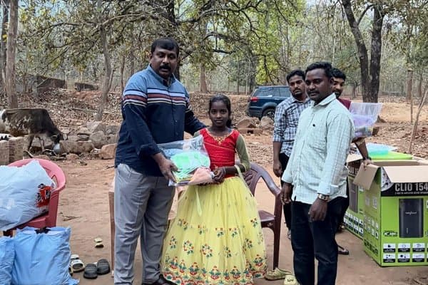 Children receiving clothing and essential supplies at a MERCE outreach camp
