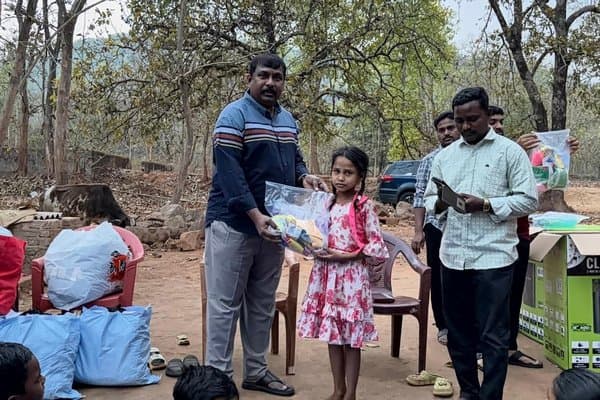 A girl receiving supplies during a community distribution event