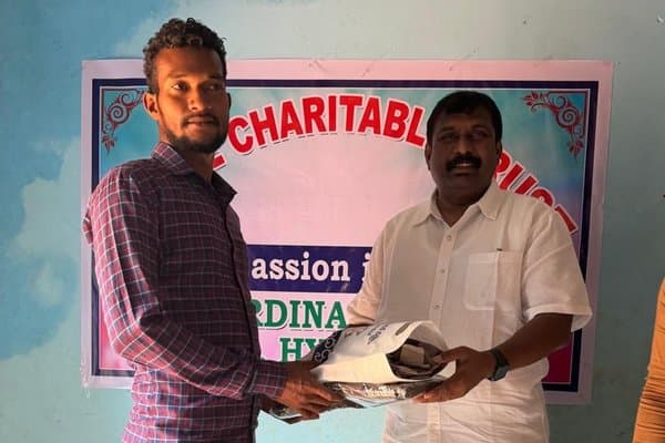 A young man receiving a supply package from an MCT leader