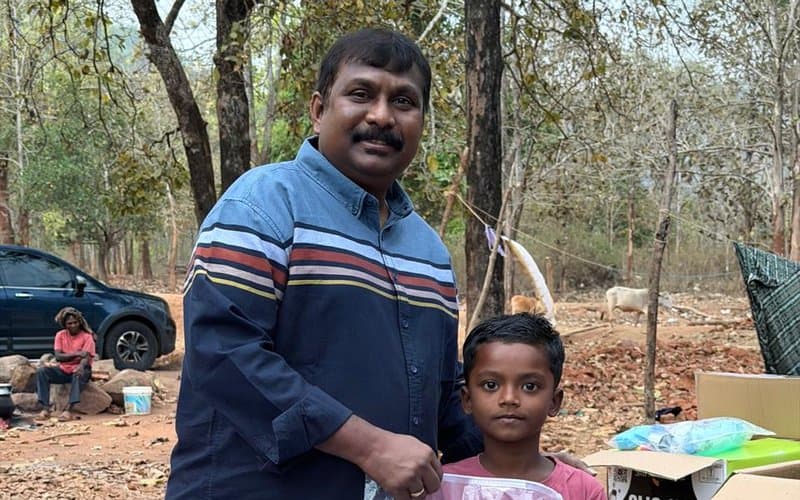 A boy receiving essential supplies from MERCE Charitable Trust