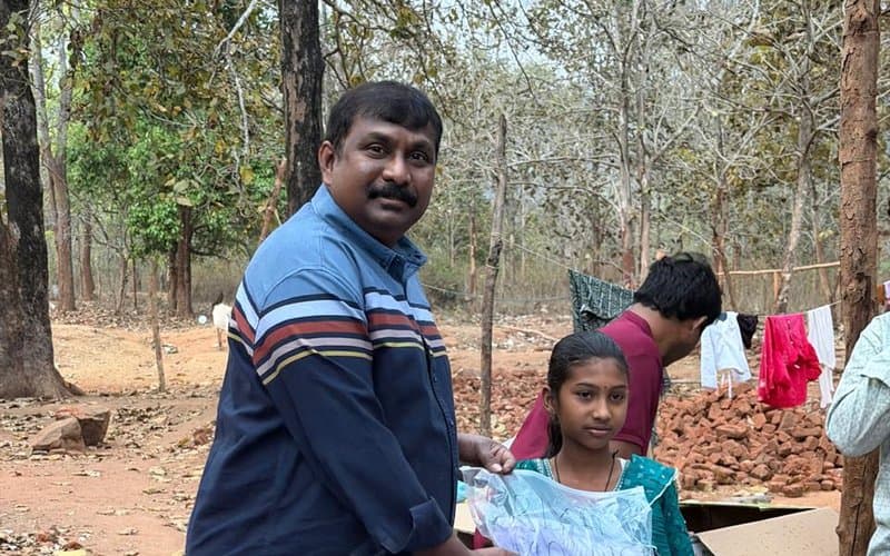 A girl receiving supplies from an MCT leader during a community outreach event