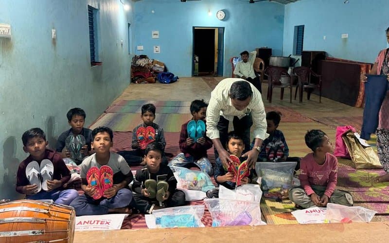 Children receiving footwear and essential supplies at an indoor distribution event